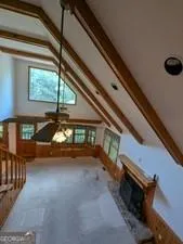 a view of a room with window furniture and front door