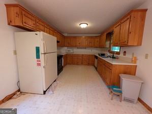 763 Sharp Top Circle Blairsville, GA 30512 - Photo 33 of 57 a kitchen with refrigerator cabinets and a sink