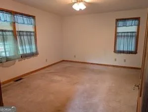 a kitchen with granite countertop a refrigerator stove top oven and sink