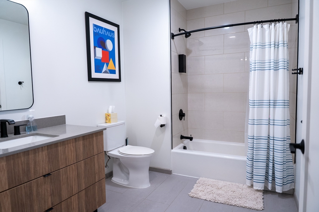 2 Sinclair Road, Unit 202 Boston, MA 02134 - Photo 16 of 23 a bathroom with a sink toilet and shower