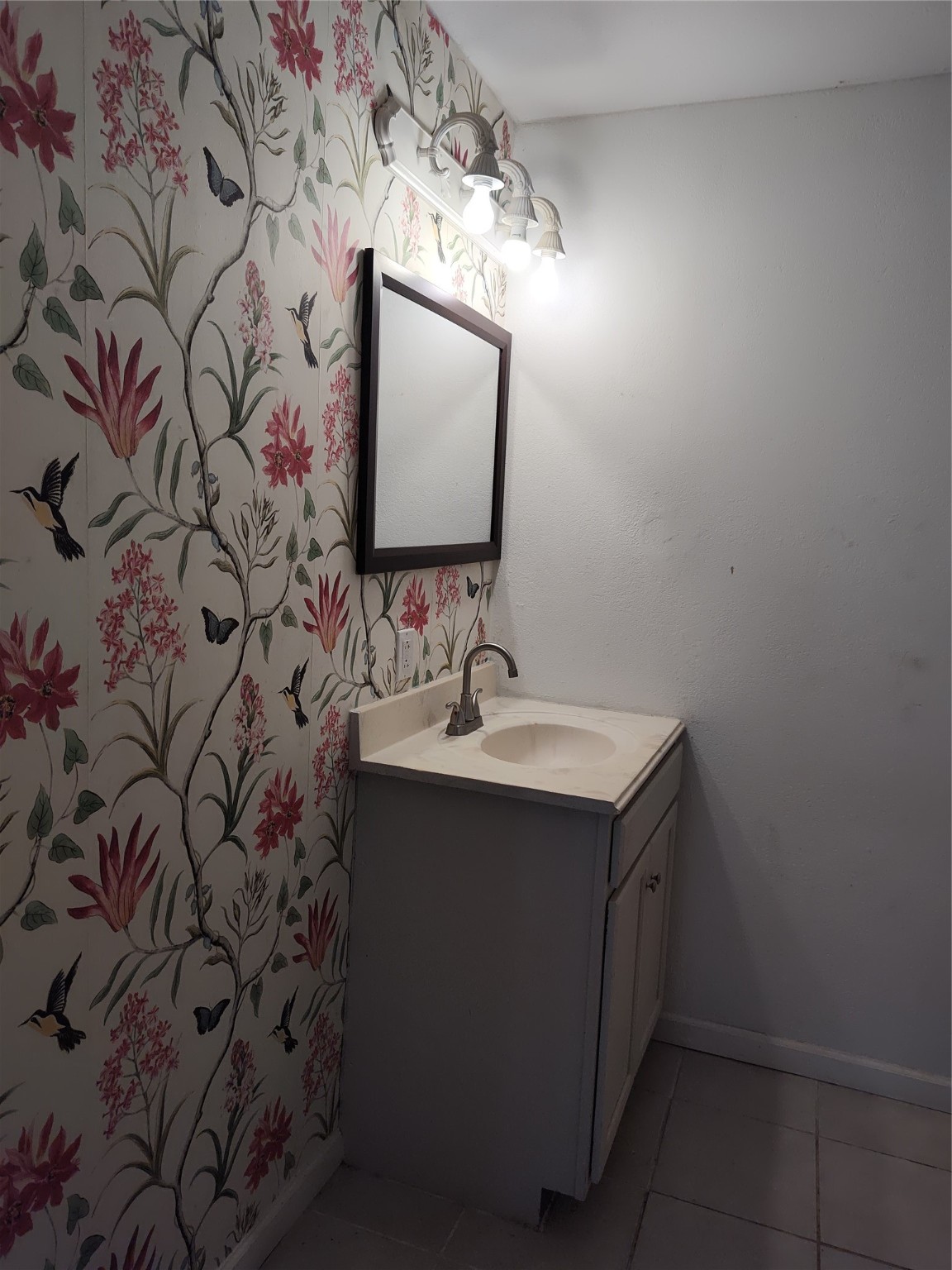 527 West 6th Street Freeport, TX 77541 - Photo 15 of 25 a bathroom with a sink and mirror with vanity