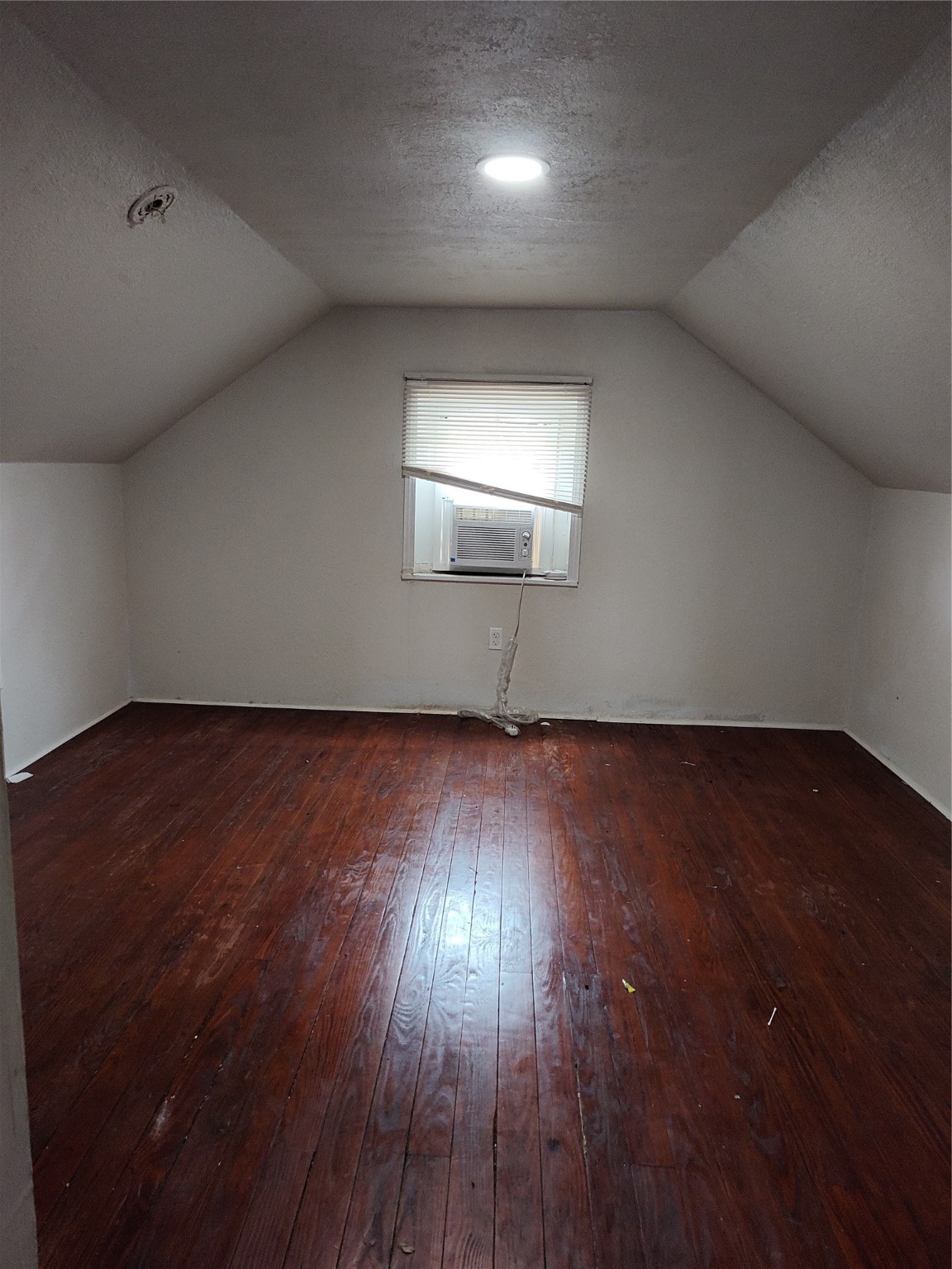 527 West 6th Street Freeport, TX 77541 - Photo 19 of 25 an empty room with wooden floor and windows