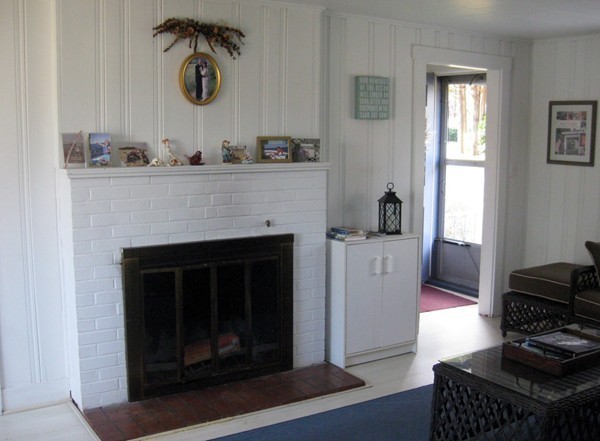 22 Benedict Road Bourne, MA 02532 - Photo 8 of 21 a living room with a fireplace and a window