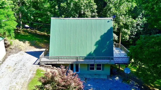 a aerial view of a house with a yard and potted plants