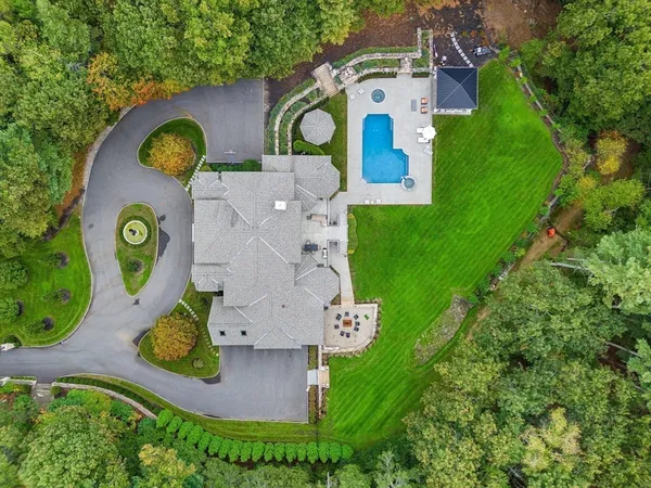 an aerial view of residential house with outdoor space and swimming pool