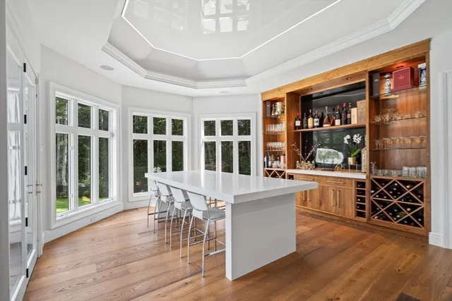 a spacious bedroom with a bed and a chandelier