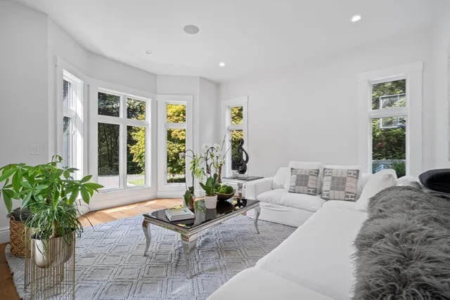 a room with pool table wooden floor and windows