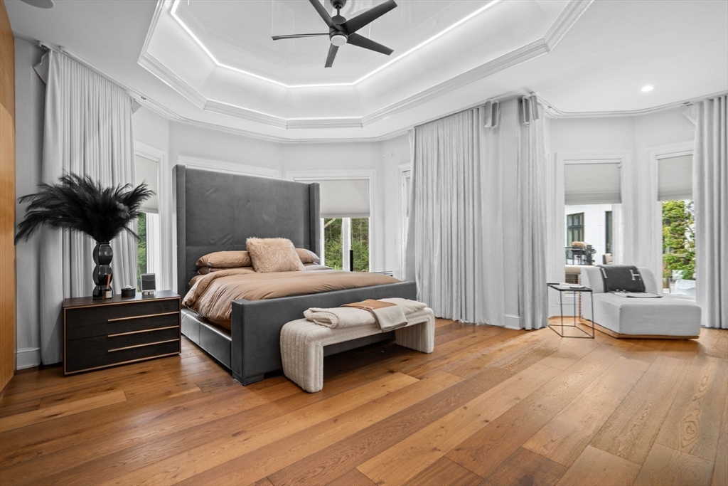497 Old Rd To 9 Acre Corner Concord, MA 01742 - Photo 14 of 42 a spacious bedroom with a bed and a chandelier