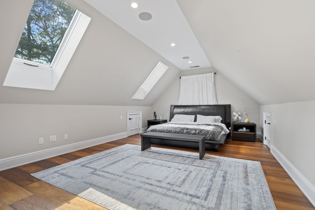 497 Old Rd To 9 Acre Corner Concord, MA 01742 - Photo 19 of 42 a spacious bedroom with a bed and a night stand