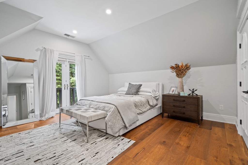 497 Old Rd To 9 Acre Corner Concord, MA 01742 - Photo 21 of 42 a bedroom with a bed and wooden floor