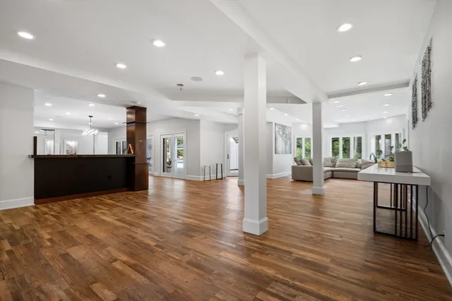 a view of a white house with a large pool and a yard