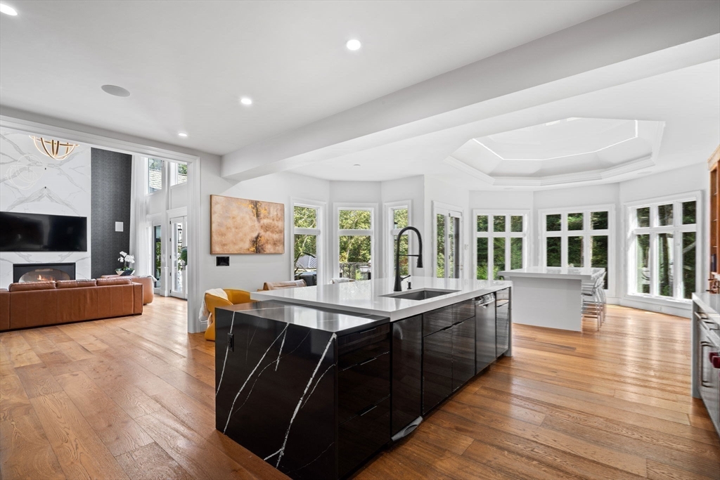 497 Old Rd To 9 Acre Corner Concord, MA 01742 - Photo 8 of 42 a living room with stainless steel appliances granite countertop a sink dishwasher and a flat screen tv