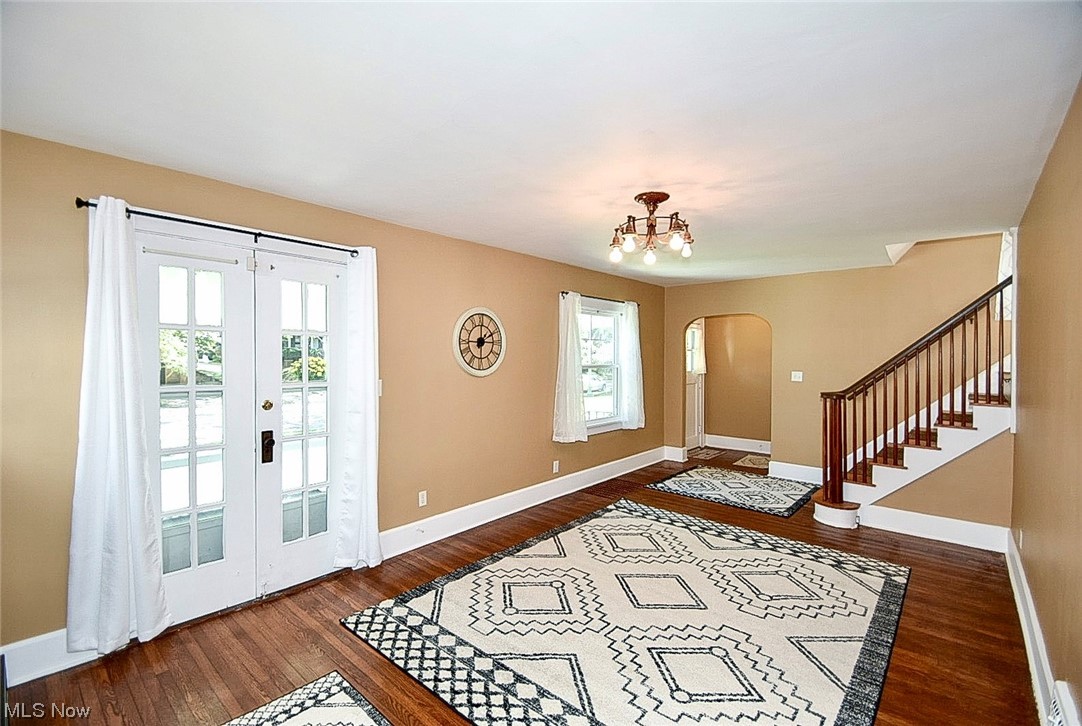 1233 Ridge Road Northwest Canton, OH 44703 - Photo 3 of 24 Foyer entrance featuring a healthy amount of sunlight and hardwood flooring and French doors leading to porch