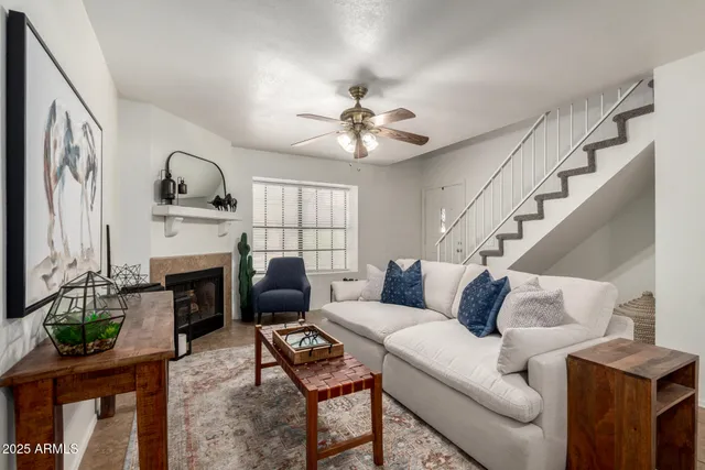 a living room with furniture a fireplace and a flat screen tv