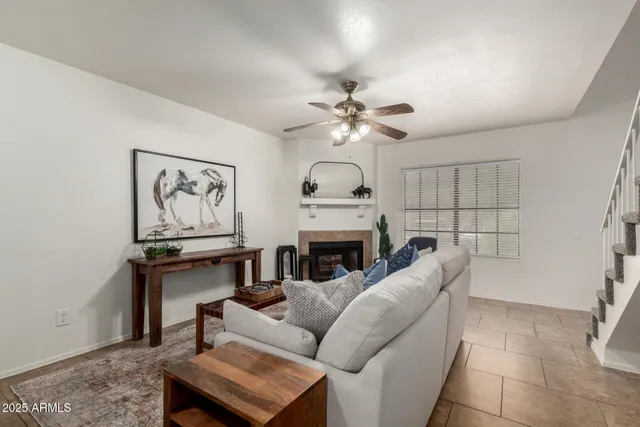 a living room with furniture a fireplace and a window