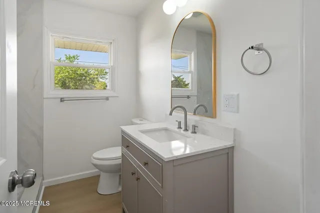 a bathroom with a toilet sink and mirror