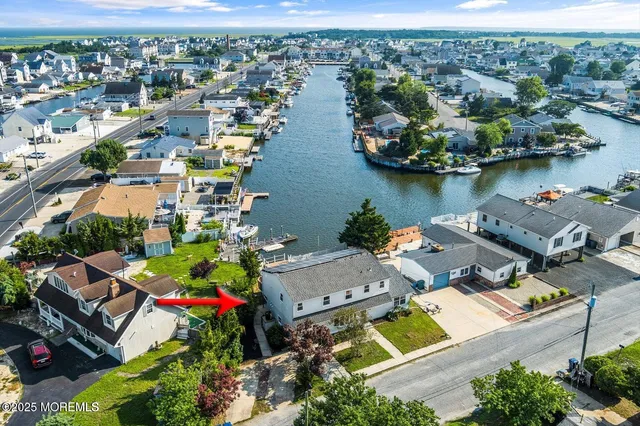 an aerial view of a houses with a lake view