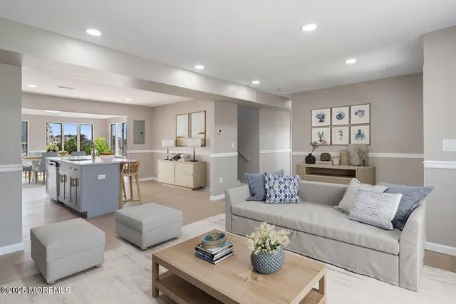 a living room with furniture and view of kitchen