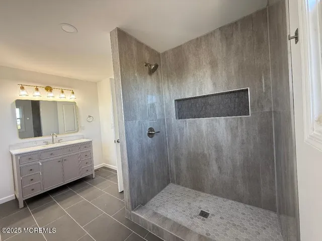 a bathroom with a shower and a sink