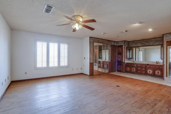 a spacious bathroom with a tub sink and mirror