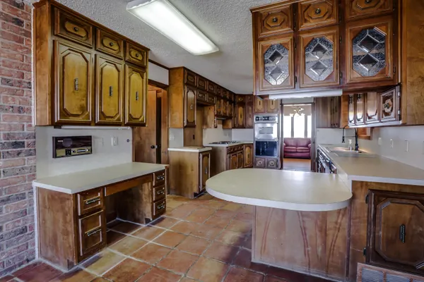 a kitchen with stainless steel appliances a sink stove and cabinets