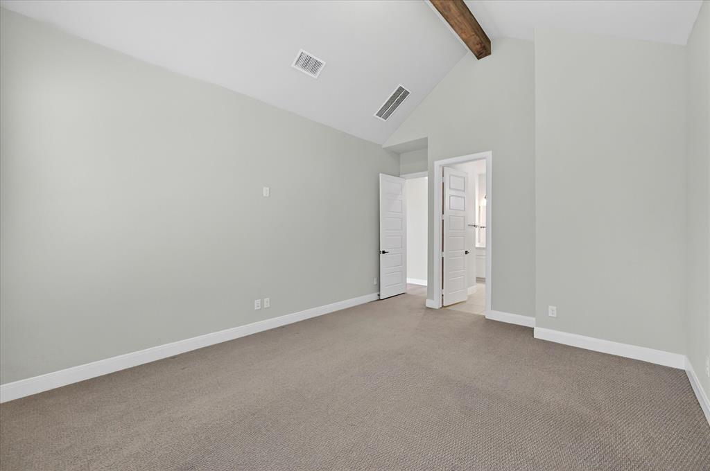2237 Pika Road Northlake, TX 76247 - Photo 18 of 37 Vaulted ceiling with an exposed wood beam, light gray walls, and plush carpeting