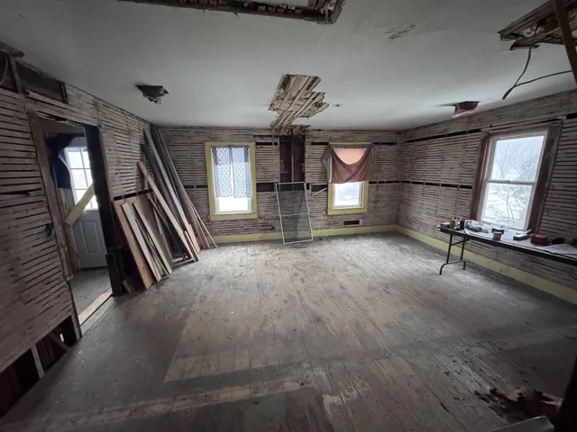 a room with a bed and a mirror