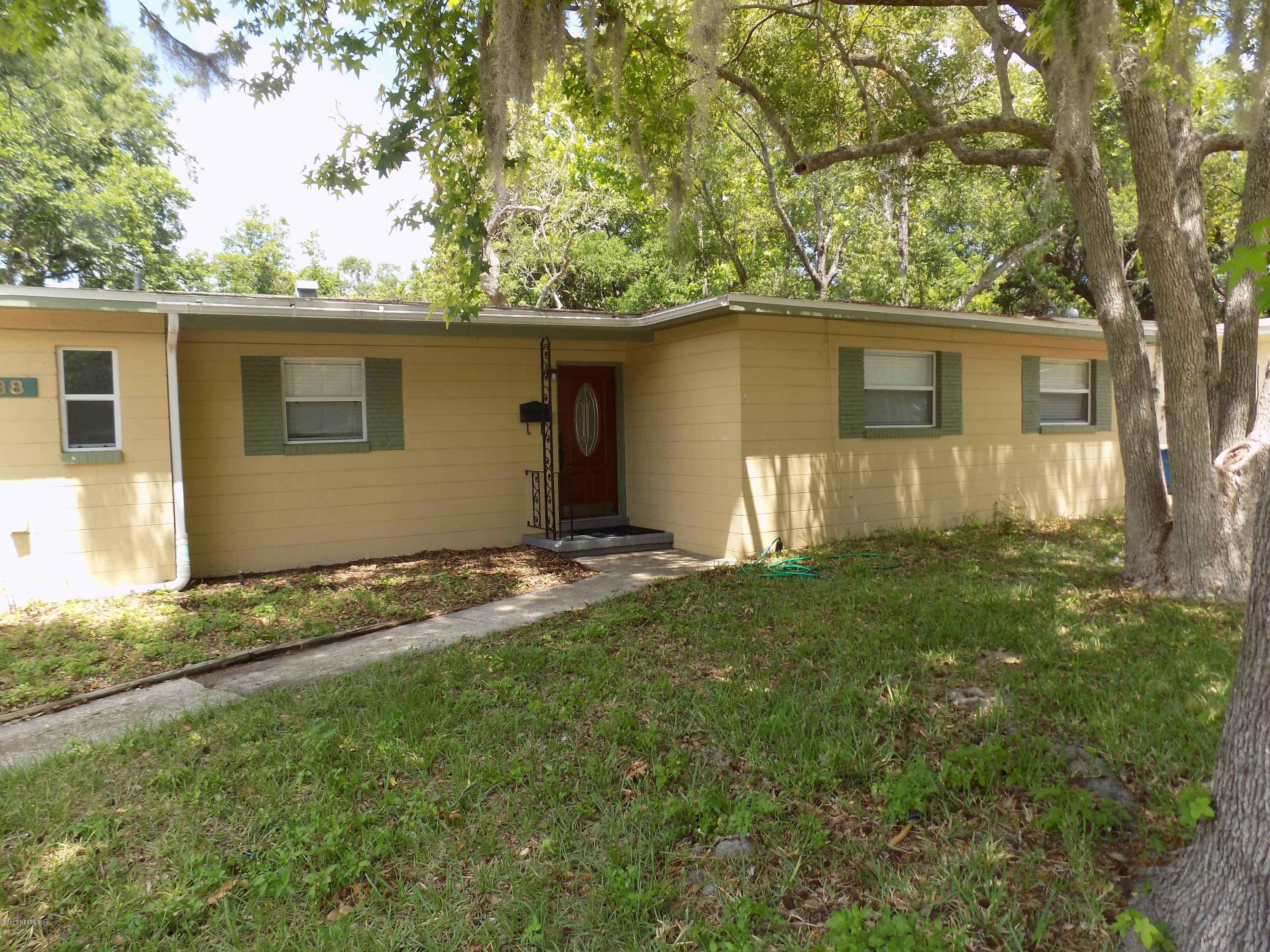 3738 Rogero Road Jacksonville, FL 32277 - Photo 1 of 22 front view of a house with a yard
