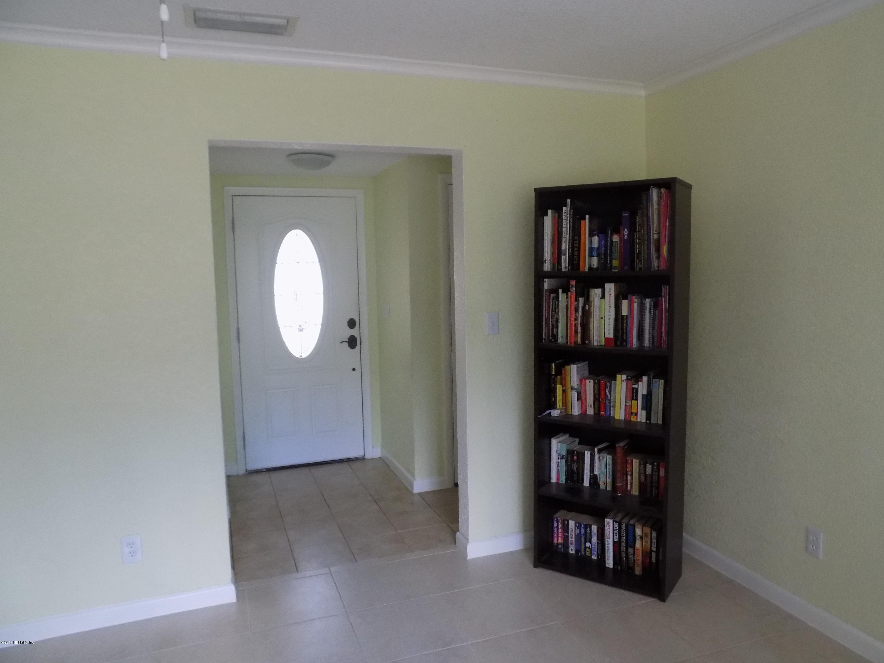 3738 Rogero Road Jacksonville, FL 32277 - Photo 2 of 22 a view of a livingroom with shelves