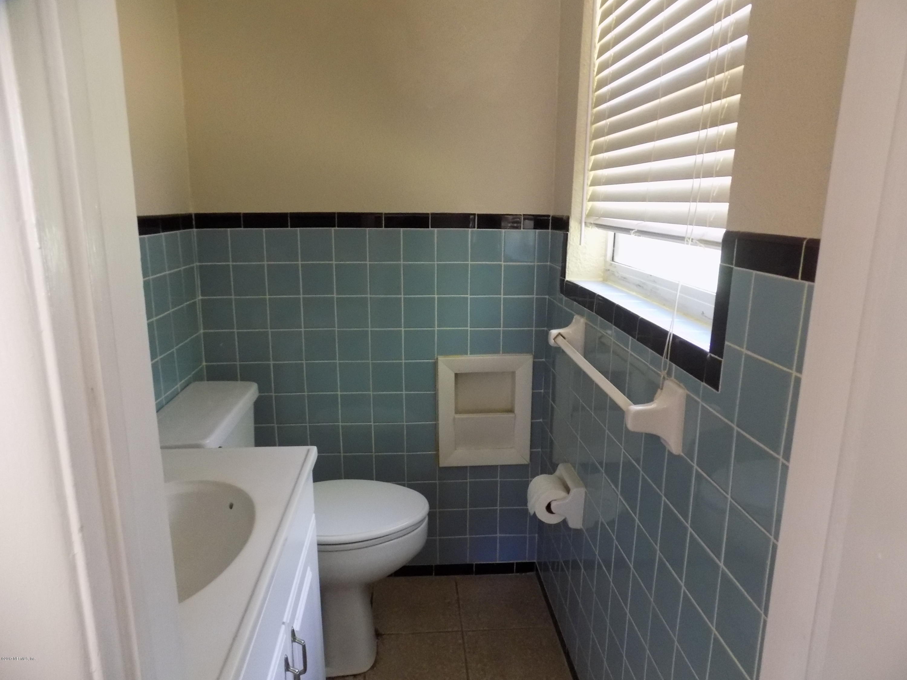 3738 Rogero Road Jacksonville, FL 32277 - Photo 14 of 22 a bathroom with a toilet and a sink