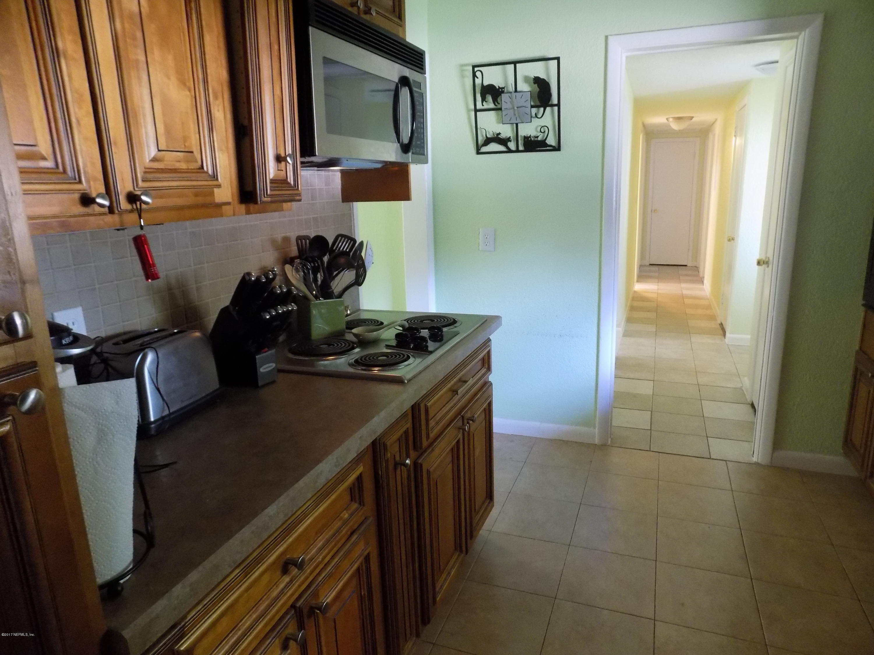 3738 Rogero Road Jacksonville, FL 32277 - Photo 15 of 22 a kitchen with a sink and cabinets