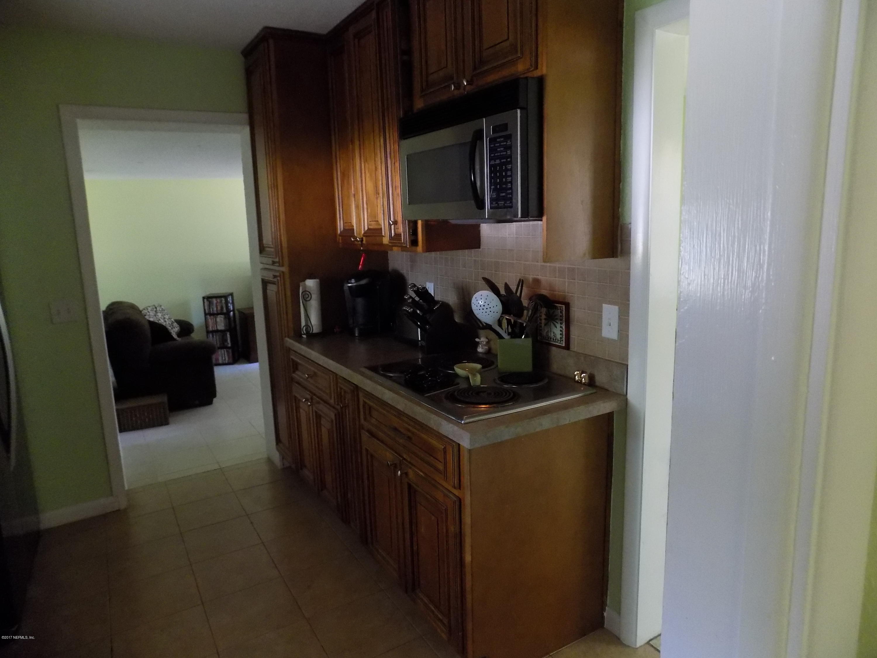 3738 Rogero Road Jacksonville, FL 32277 - Photo 16 of 22 a kitchen with stainless steel appliances granite countertop a stove and a sink