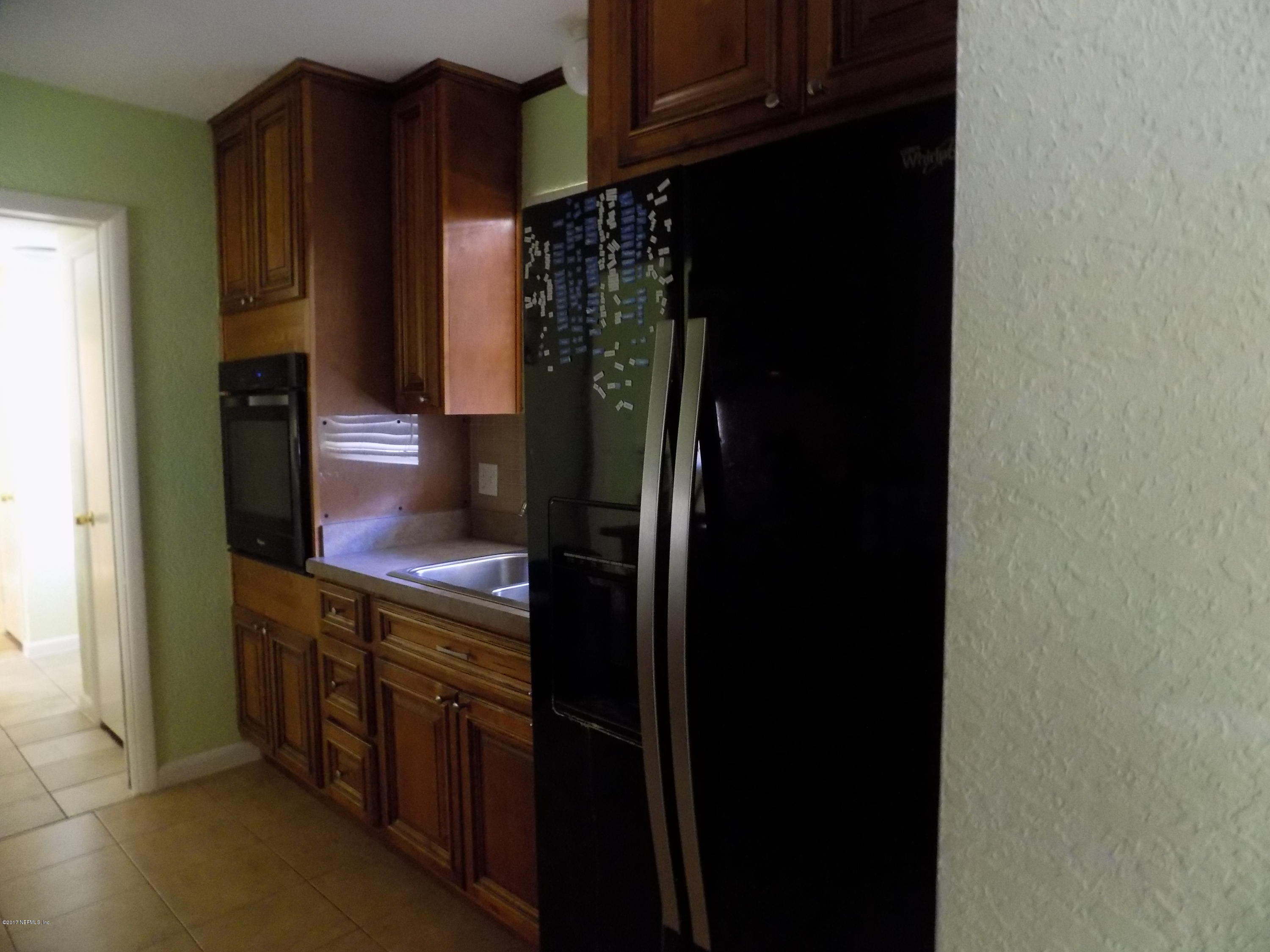 3738 Rogero Road Jacksonville, FL 32277 - Photo 17 of 22 a kitchen with stainless steel appliances granite countertop a refrigerator and a stove