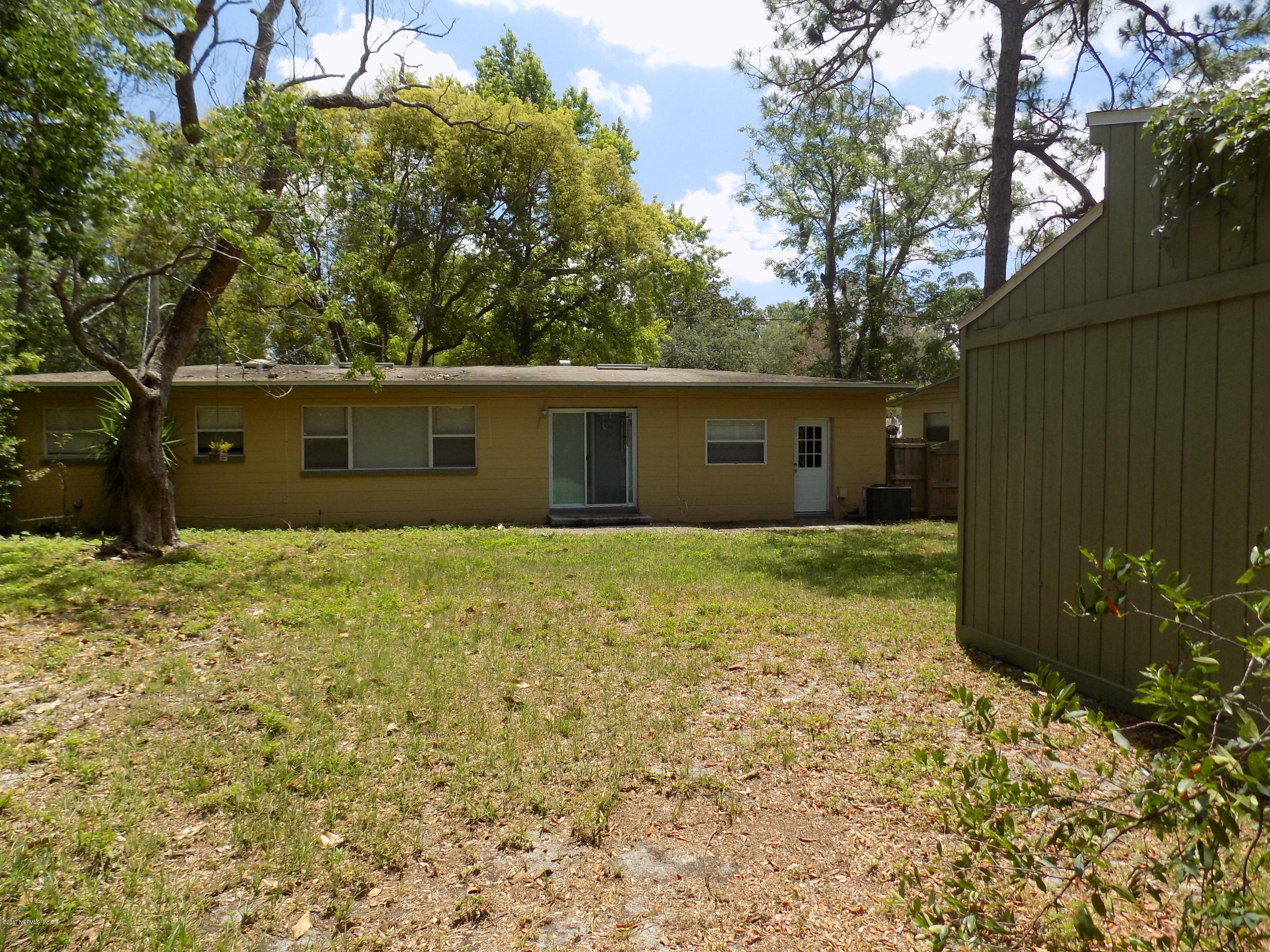 3738 Rogero Road Jacksonville, FL 32277 - Photo 20 of 22 a view of a house with a yard