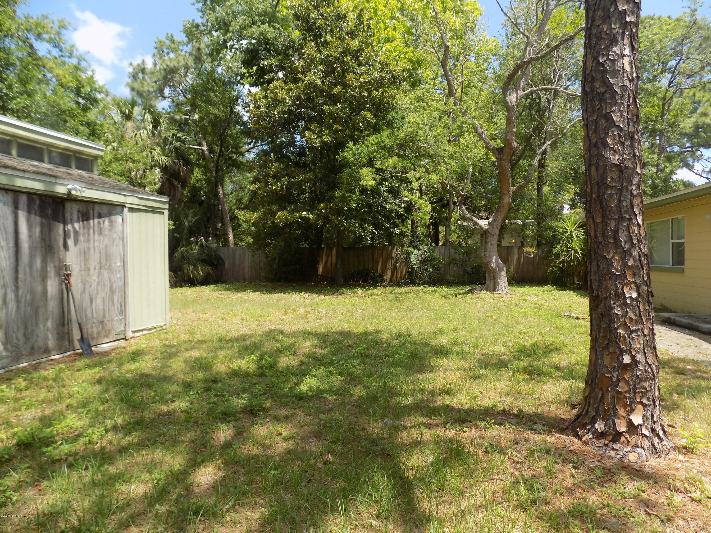 3738 Rogero Road Jacksonville, FL 32277 - Photo 21 of 22 a view of a yard with large trees