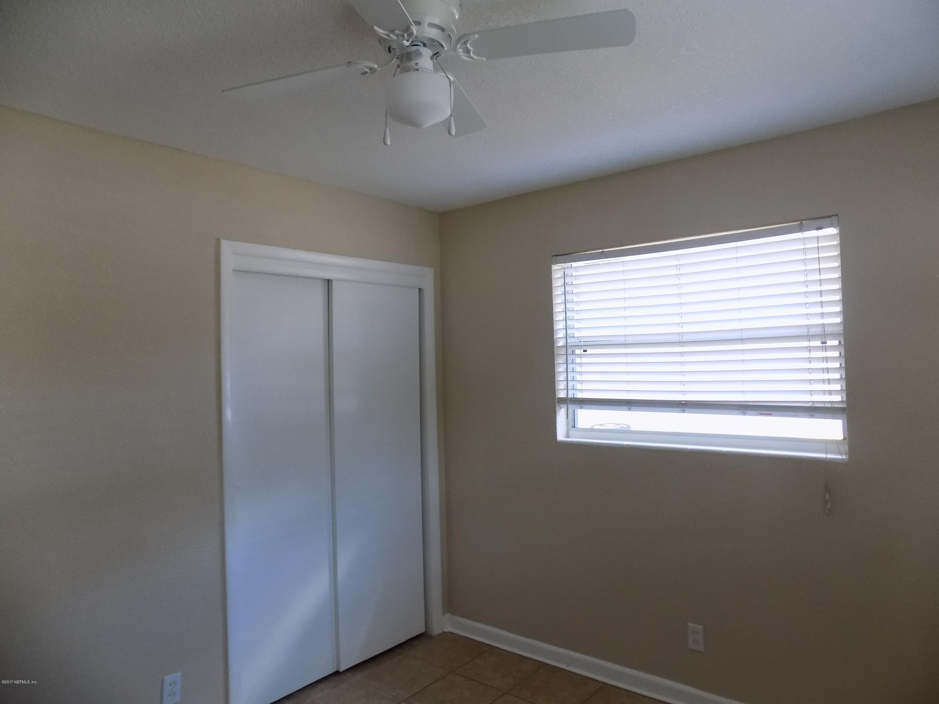 3738 Rogero Road Jacksonville, FL 32277 - Photo 10 of 22 a view of an empty room with a window