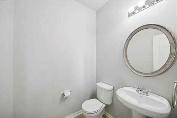 a kitchen with stainless steel appliances granite countertop a stove top oven a sink a dining table and chairs