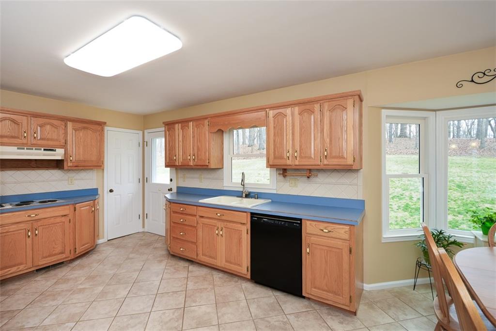 883 Tilley Road Talking Rock, GA 30175 - Photo 15 of 88 a kitchen with stainless steel appliances granite countertop a stove sink and cabinets