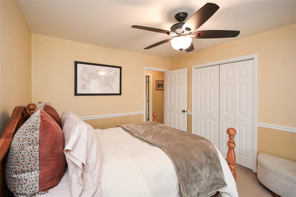 883 Tilley Road Talking Rock, GA 30175 - Photo 30 of 88 a bedroom with a bed and a chandelier