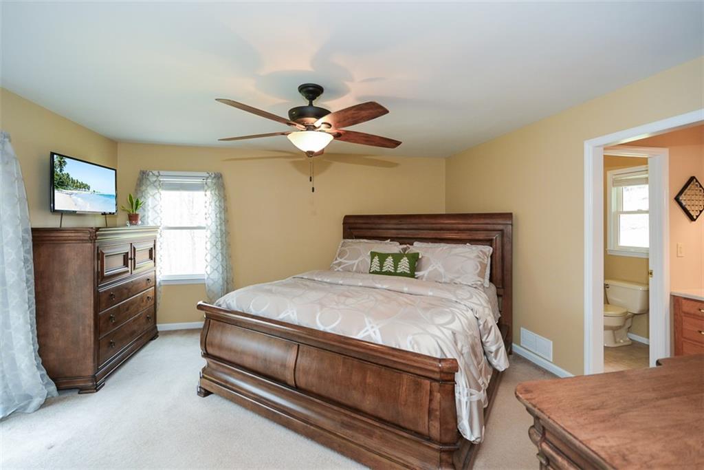 883 Tilley Road Talking Rock, GA 30175 - Photo 32 of 88 a bedroom with a bed and a chandelier