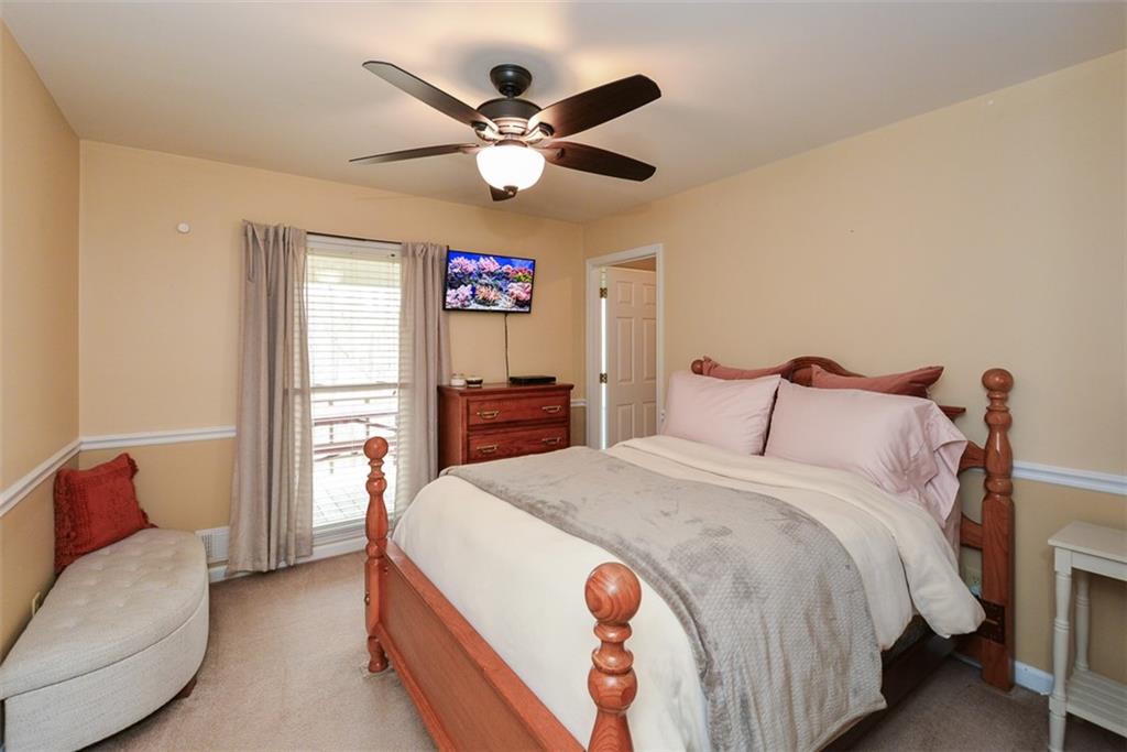 883 Tilley Road Talking Rock, GA 30175 - Photo 36 of 88 a spacious bedroom with a bed and a chandelier