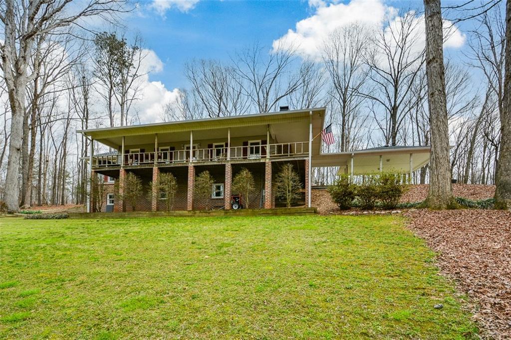 883 Tilley Road Talking Rock, GA 30175 - Photo 4 of 88 a view of a house with a yard and large trees