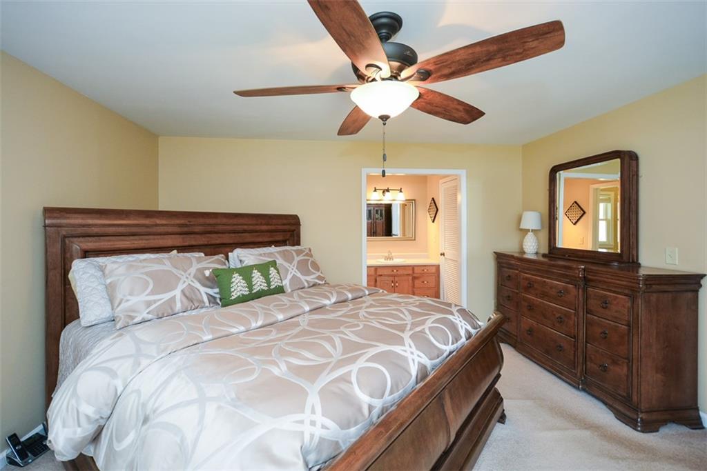883 Tilley Road Talking Rock, GA 30175 - Photo 41 of 88 a bedroom with a bed and wooden floor