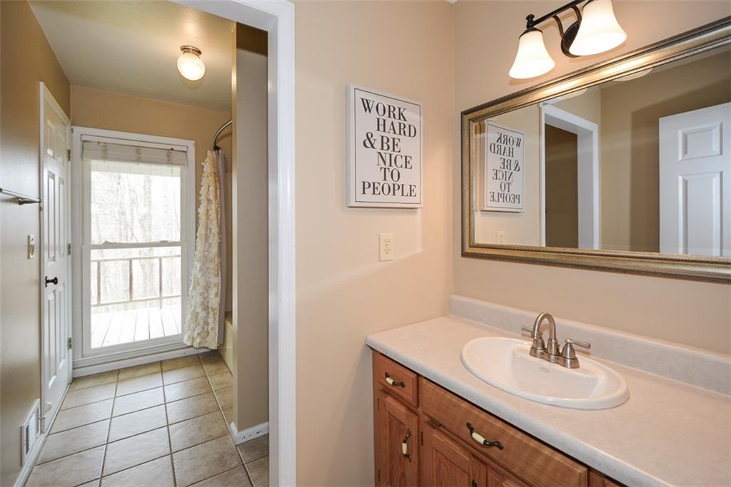883 Tilley Road Talking Rock, GA 30175 - Photo 43 of 88 a bathroom with a sink a vanity and a mirror