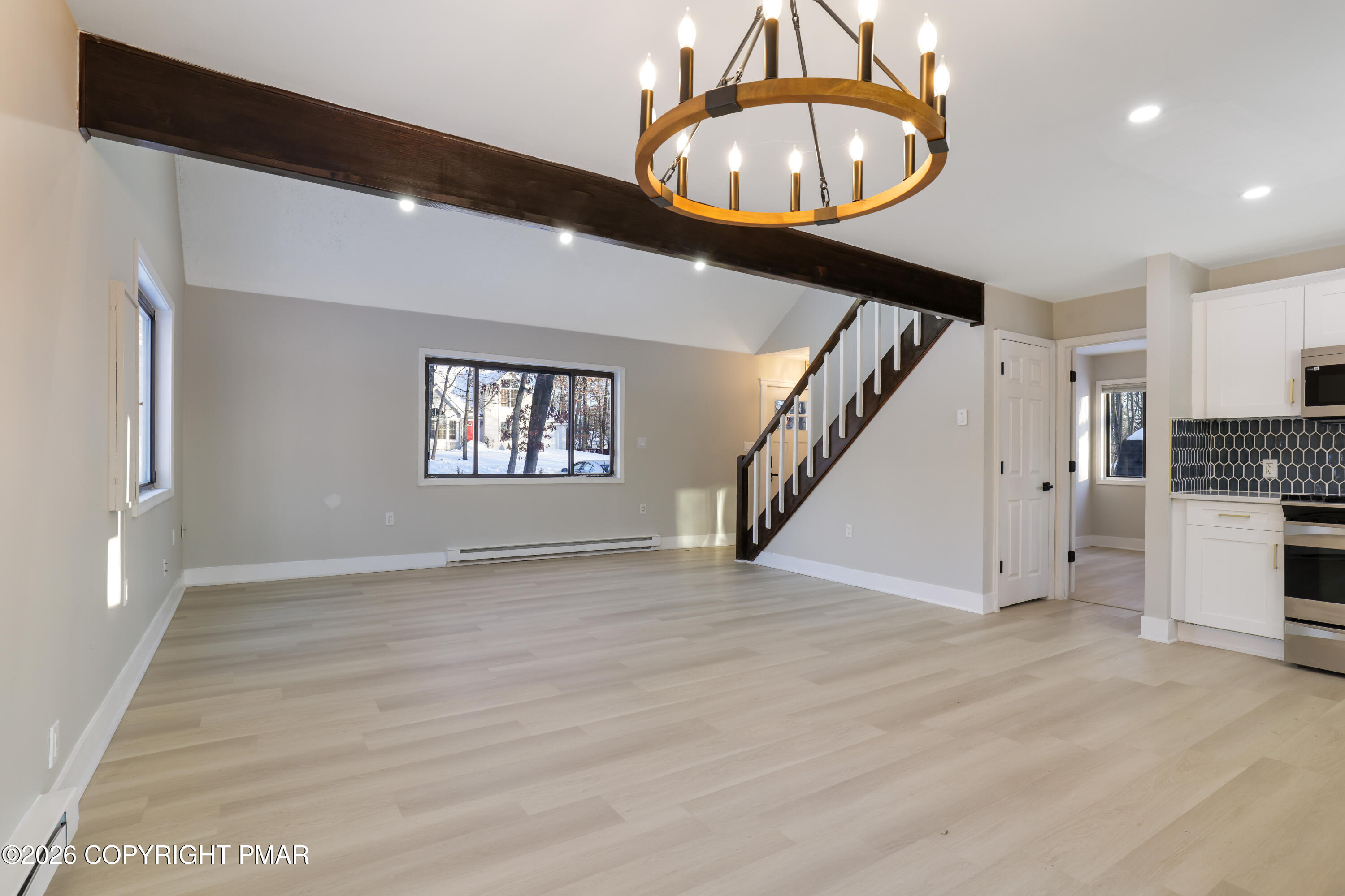 147 Pocono Boulevard Bushkill, PA 18324 - Photo 12 of 38 an empty room with wooden floor and staircase