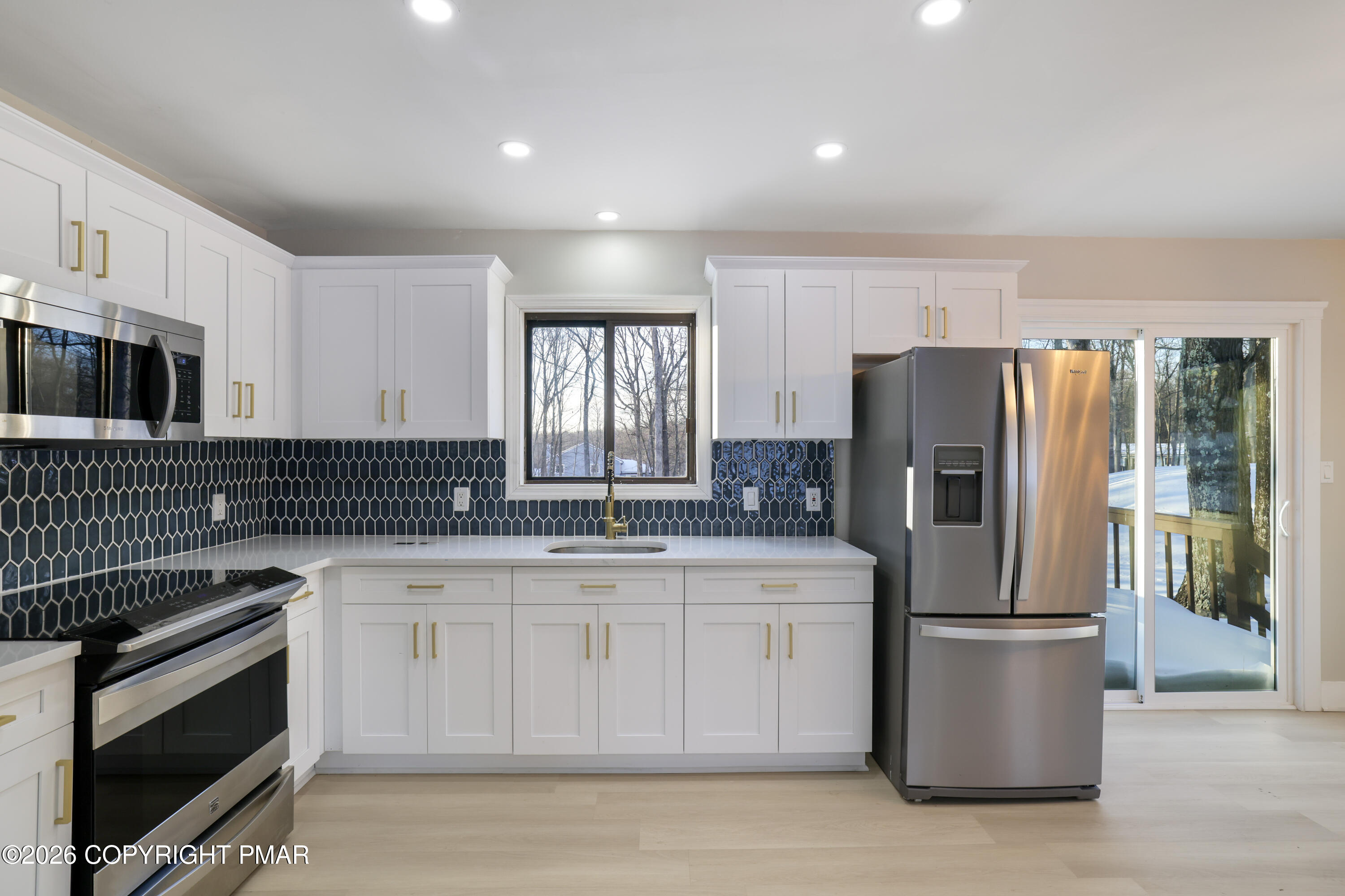 147 Pocono Boulevard Bushkill, PA 18324 - Photo 13 of 38 a kitchen with a sink stove and refrigerator