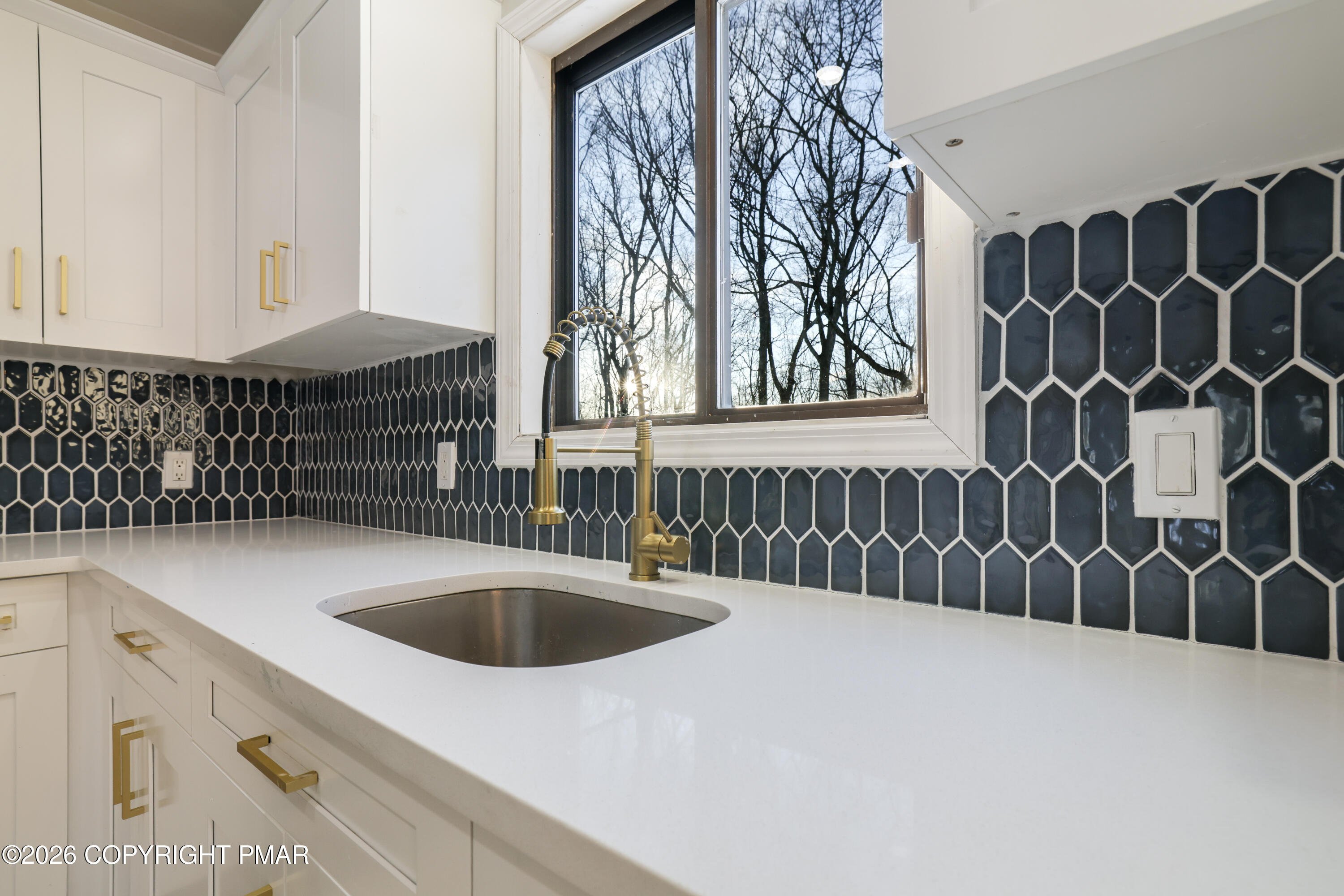 147 Pocono Boulevard Bushkill, PA 18324 - Photo 15 of 38 a kitchen with a sink and cabinets