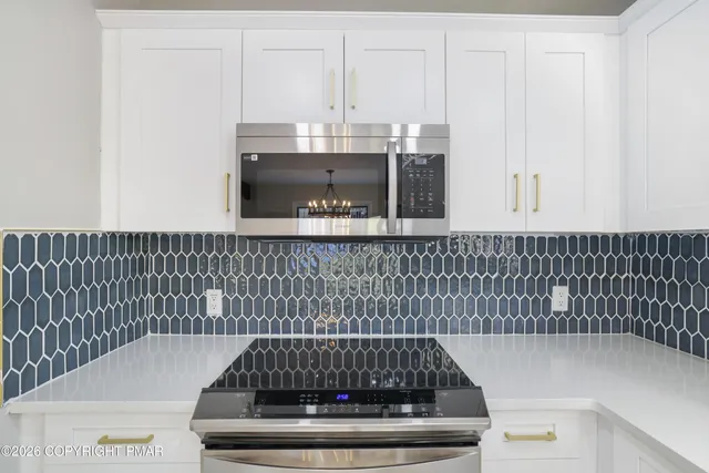 a kitchen with stainless steel appliances a refrigerator sink and microwave