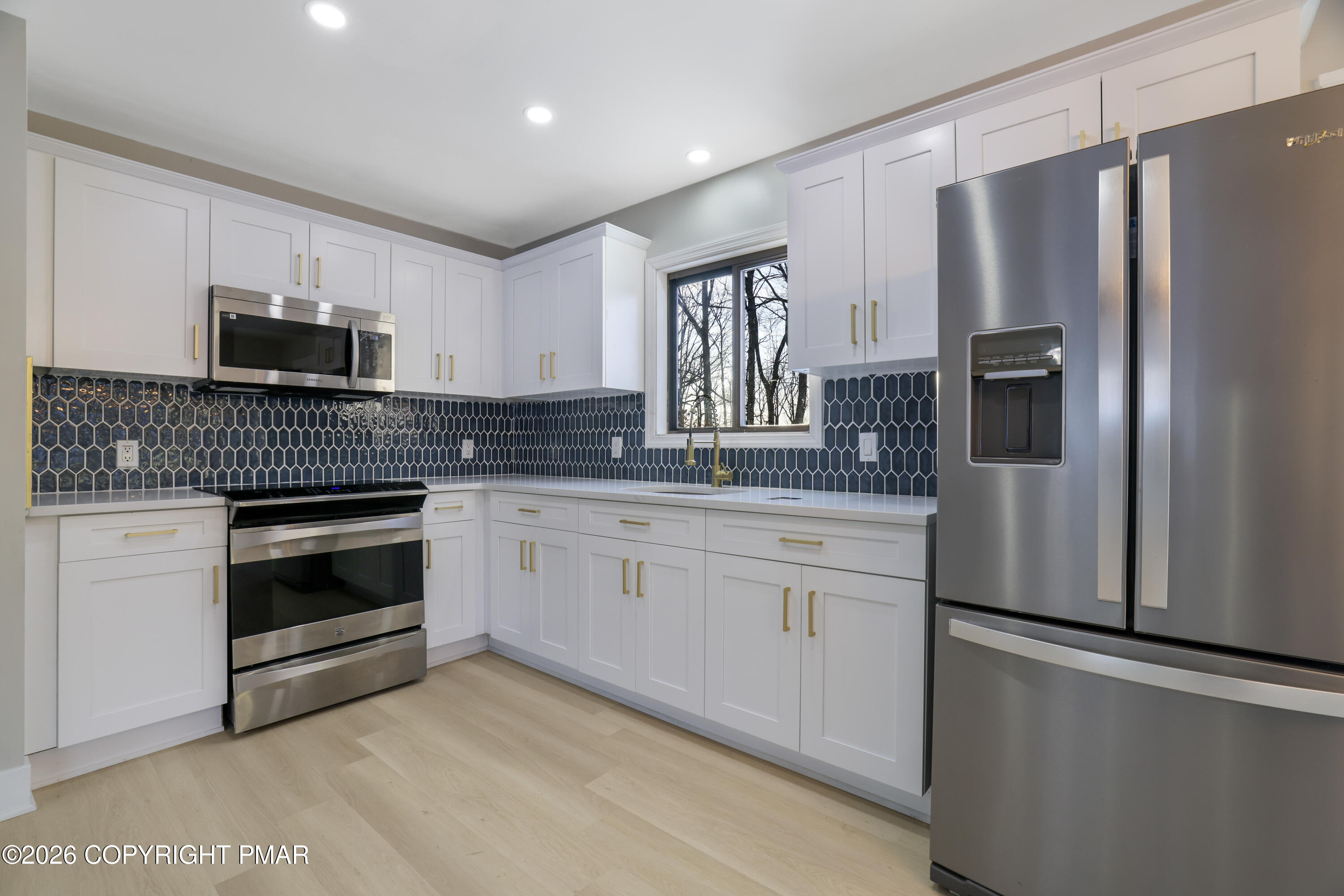 147 Pocono Boulevard Bushkill, PA 18324 - Photo 17 of 38 a kitchen with stainless steel appliances a refrigerator sink and microwave
