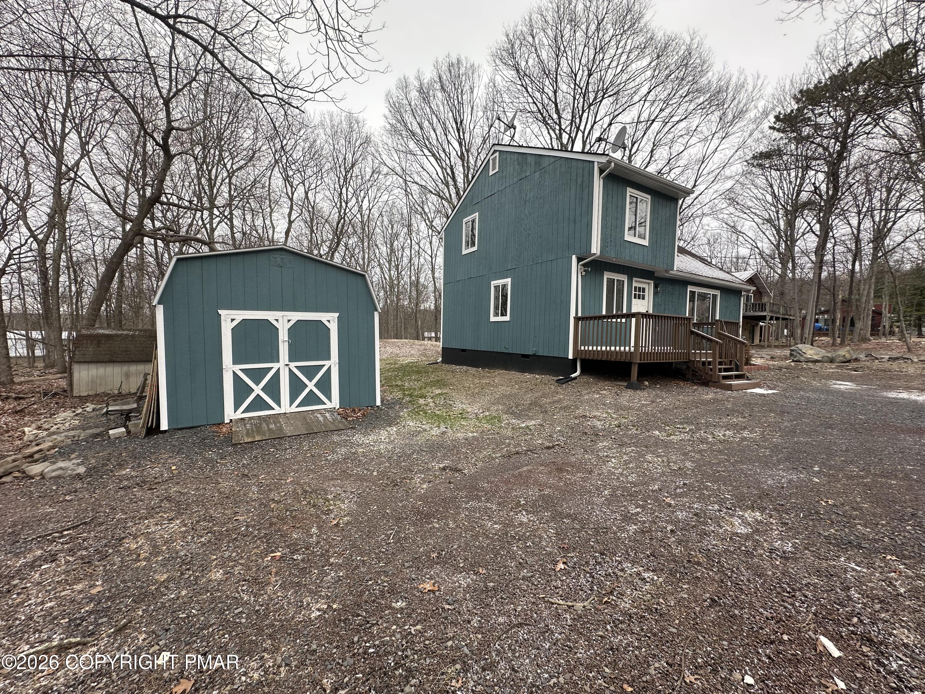 147 Pocono Boulevard Bushkill, PA 18324 - Photo 3 of 38 a front view of a house with a yard and garage